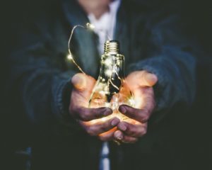 male hands holding Edison lightbulb