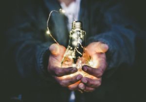 male hands holding Edison lightbulb